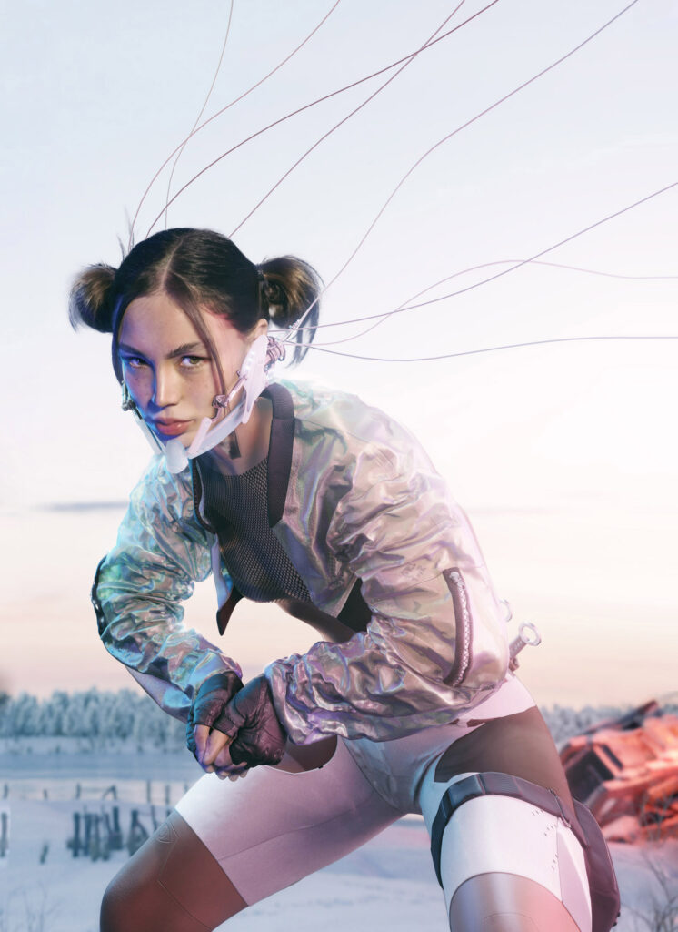 Darian Rojas A futuristic woman with wires connected to her head crouches in a snowy landscape wearing a shimmering jacket and holding a device.